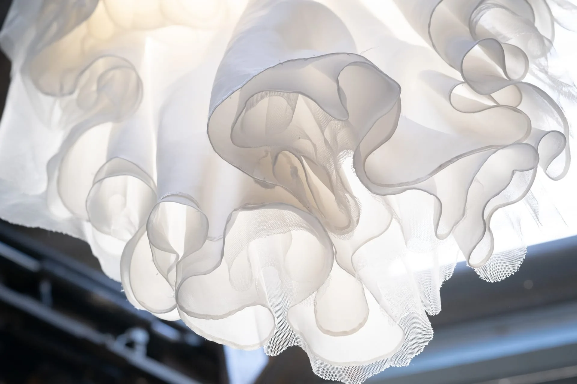 Light shawl draped softly over a shoulder in a warm neutral tone