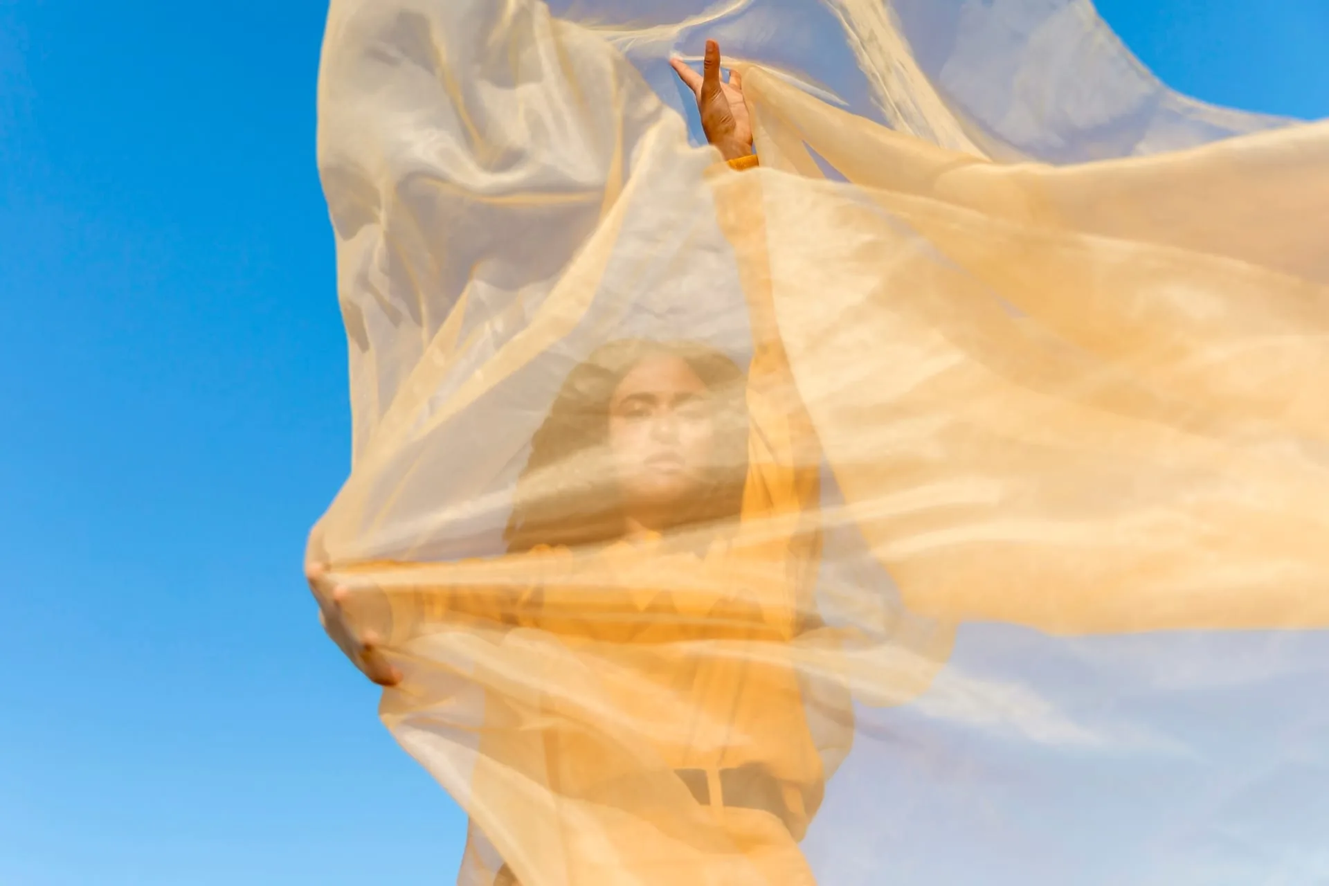 Layers of sheer tulle and chiffon fabric lengths in soft, translucent tones